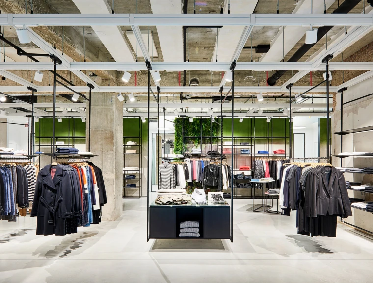 young womens fashion store - complete redesign - Kaiser Freiburg - interior architecture - wide angle store overview - green wall - steel racks