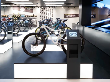 bike sports specialist store - new conception - Rose Biketown Munich - bike display luminescent podium - informal ipad station - geometrical podium arrangement