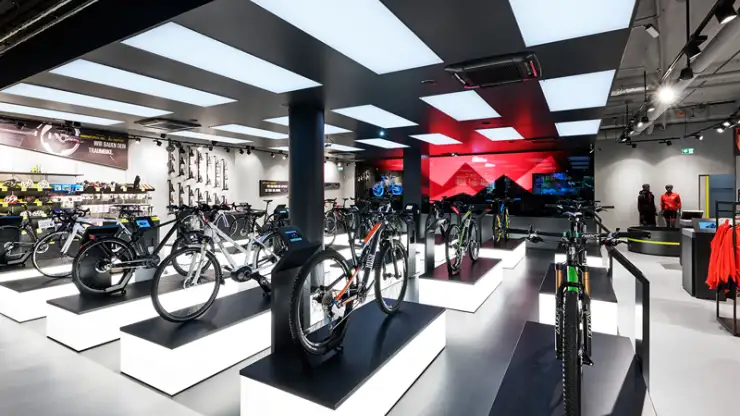 bike sports specialist store - new conception - Rose Biketown Munich - inside store overview - bike display luminescent podiums - led wall in back