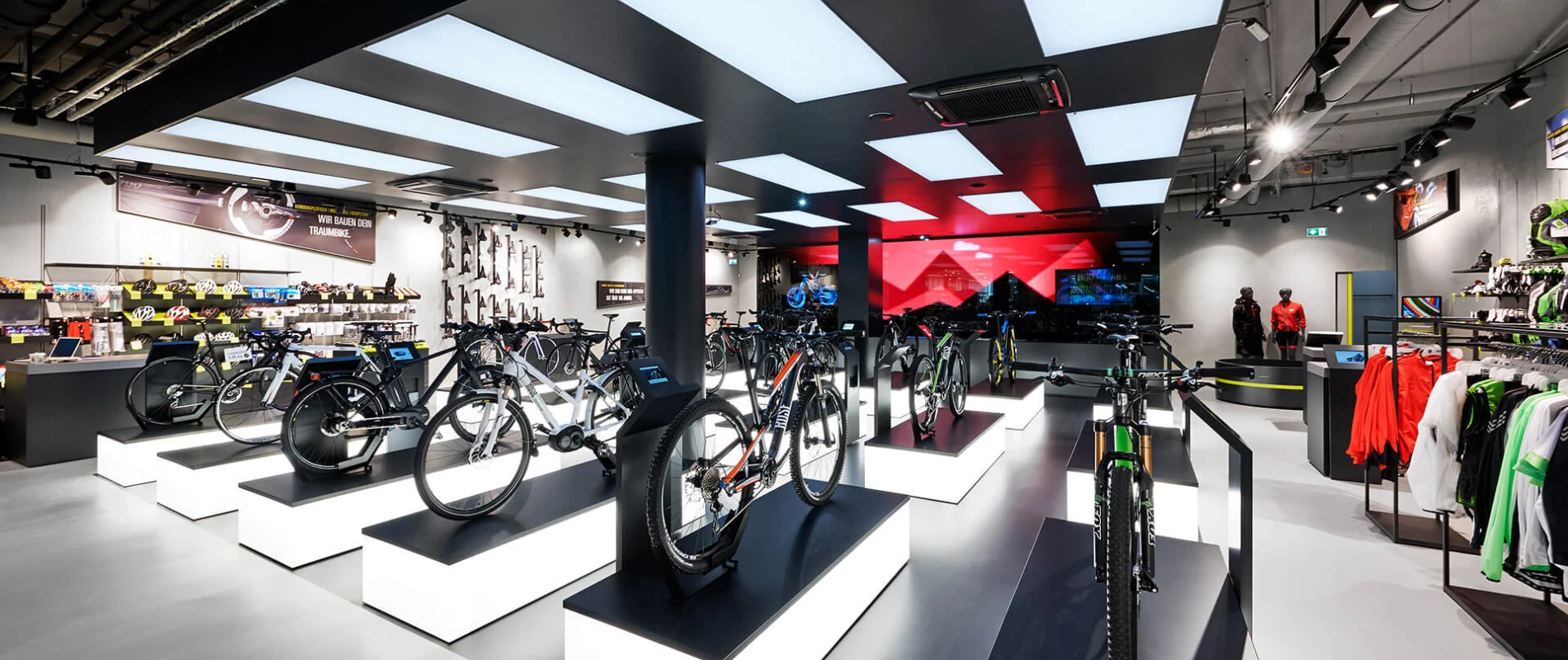 bike sports specialist store - new conception - Rose Biketown Munich - inside store overview - bike display luminescent podiums - led wall in back