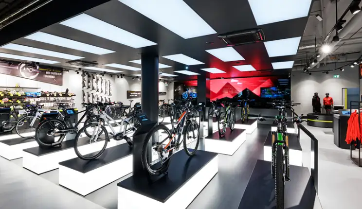 bike sports specialist store - new conception - Rose Biketown Munich - inside store overview - bike display luminescent podiums - led wall in back