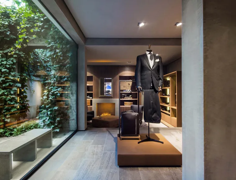 Flagship Store - luxury brand - clothing and suits - Scabal Brussels - panoramic window to planted backyard - leather covered display box - patio