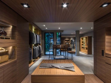 Flagship Store - luxury brand - clothing and suits - Scabal Brussels - wooden cladded display walls - view towards setup bar table