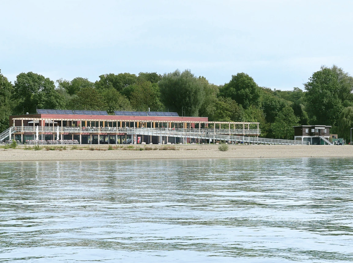 gastronomy building - construction - green building standards - competition - Strandbad Mannheim - building facade - view from riversite - rhine - building and terrace on stilts