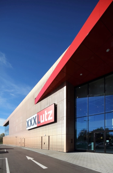 furniture store - new construction - XXXLutz Kempten - entrance - facade materials - logo